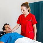 Sports Massage Consultation**

"A professional sports massage therapist in a bright, clean clinic setting, fully clothed in scrubs, consulting with a client (also fully clothed in athletic wear) about their training regimen and muscle concerns. The therapist is attentively listening and taking notes. Natural lighting, friendly atmosphere, safe for work, appropriate content, perfect anatomy, natural proportions, professional setting, modest clothing."

**